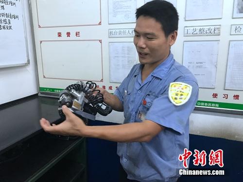 程海良講解檢修零部件要領。<a target='_blank' href='http://www.chinanews.com/' ></table>中新網</a> 吳濤 攝